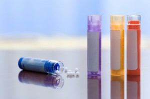 Close view of homeopathic medications - containers and small white balls